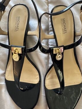 MICHAEL Michael Kors Black Patent T-Strap Sandals with Gold Logo Charm